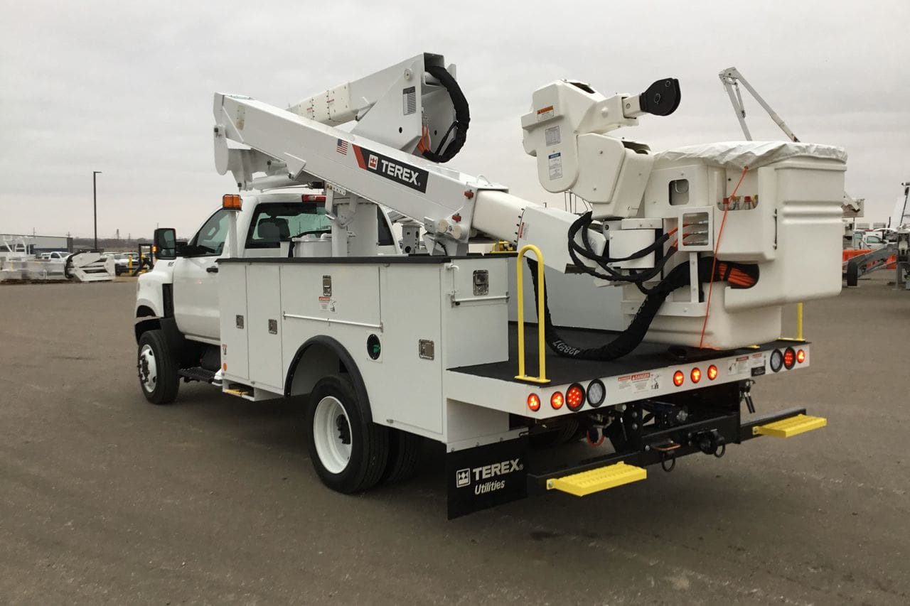 A white truck with a crane on the back