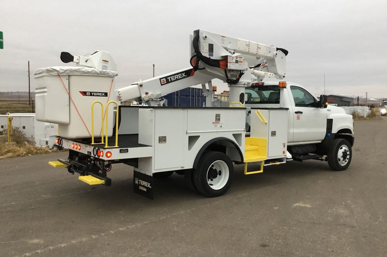 A white truck with a crane on the back