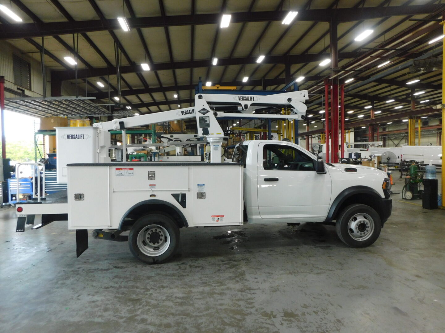 A white truck with a crane on the back