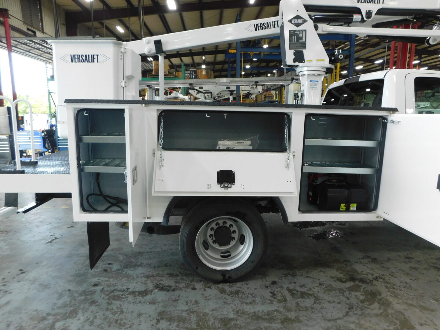 A white utility truck with open doors and shelves.