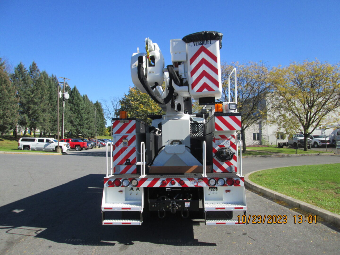 A large white truck with red and white stripes on it.