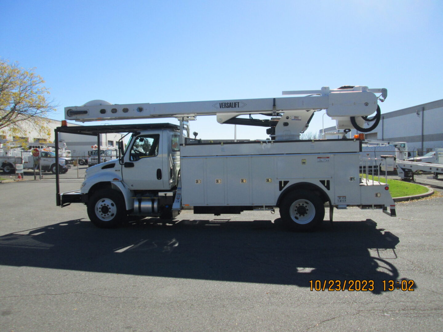 A white truck with a crane on the back