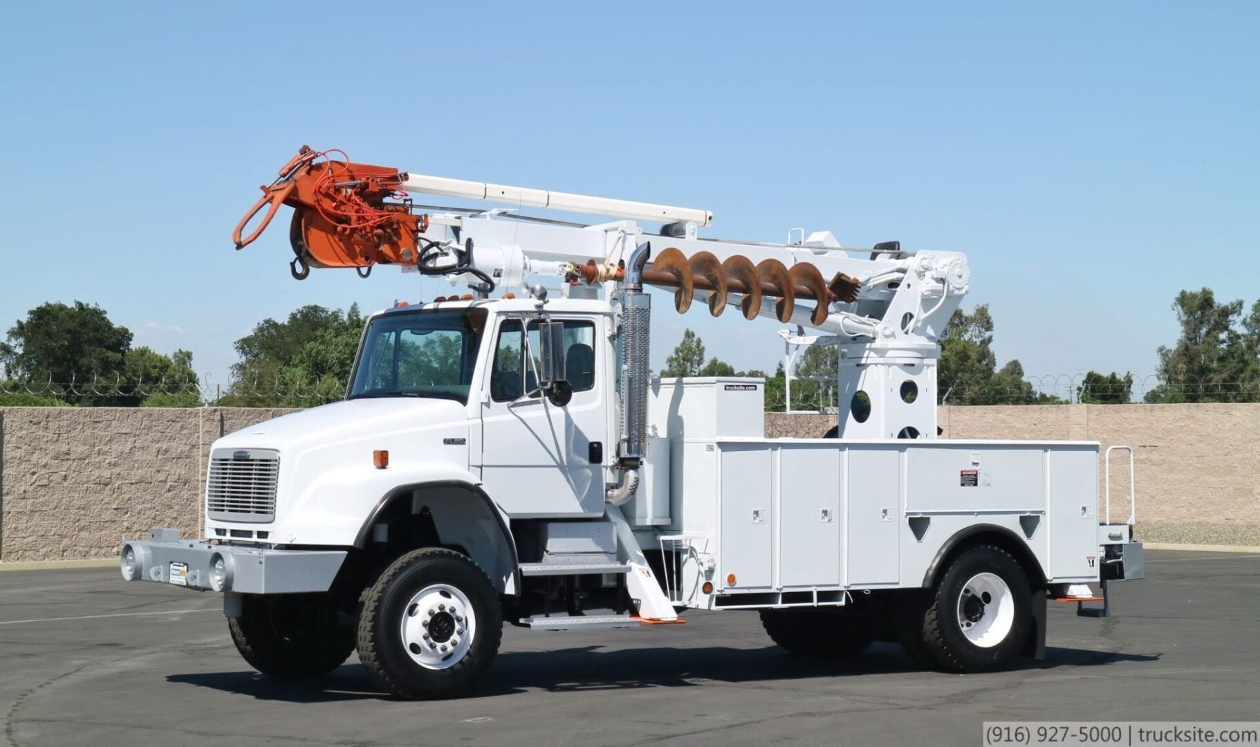 A white truck with an orange bucket on the back.