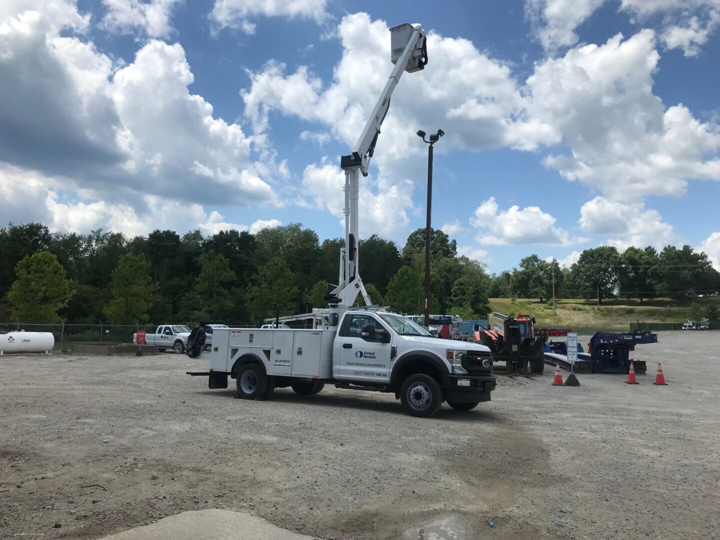 A white truck with a crane on it's back.