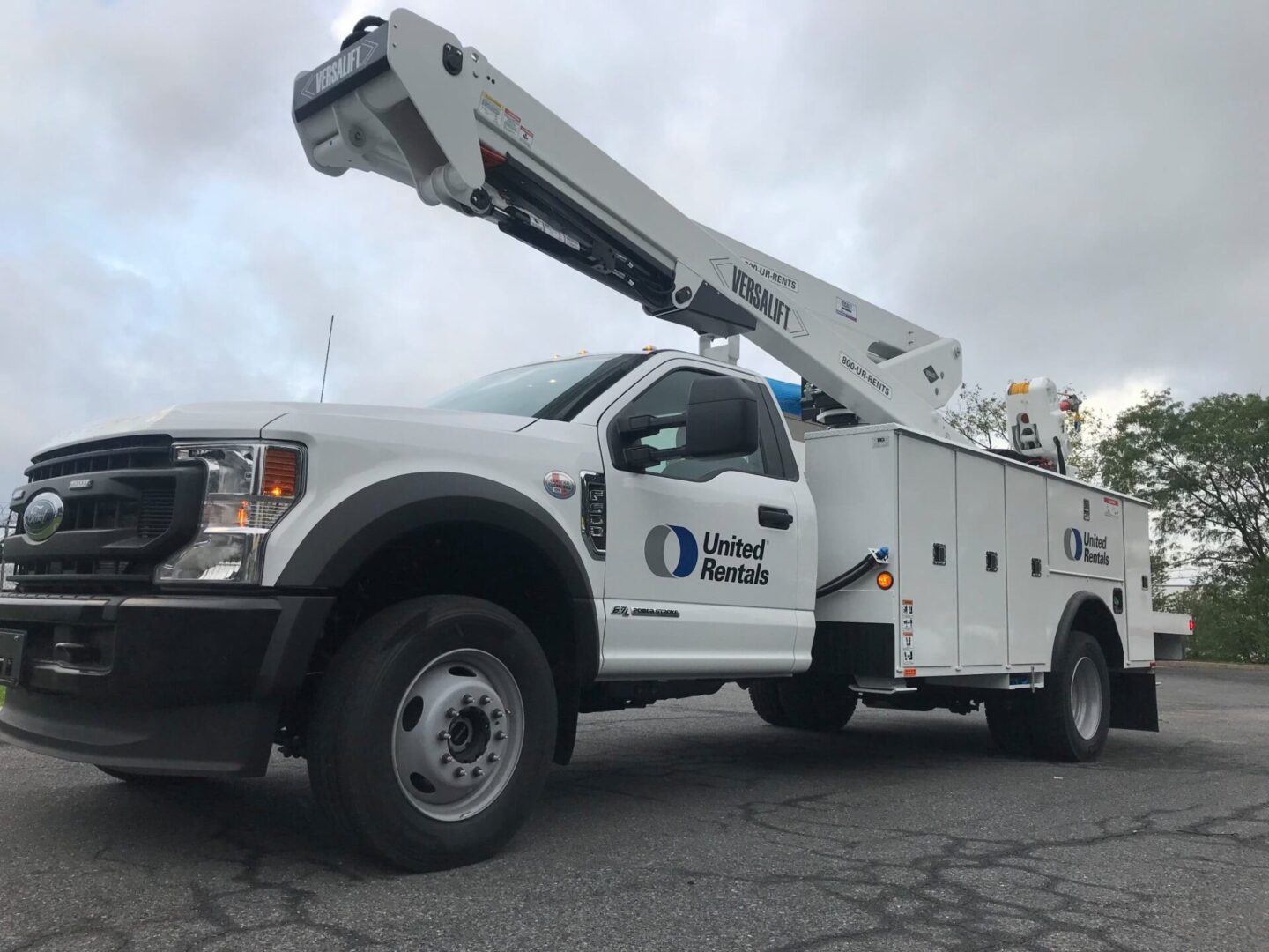 A white truck with a crane on the back