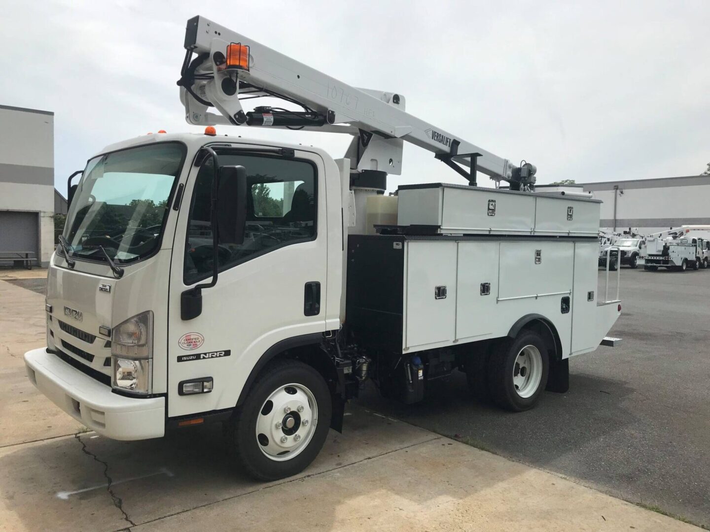 A white truck with a crane on the back